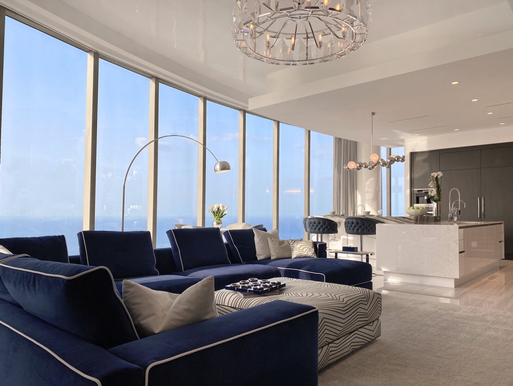Spaces- luxury penthouse, open space kitchen and living room, blue sofa