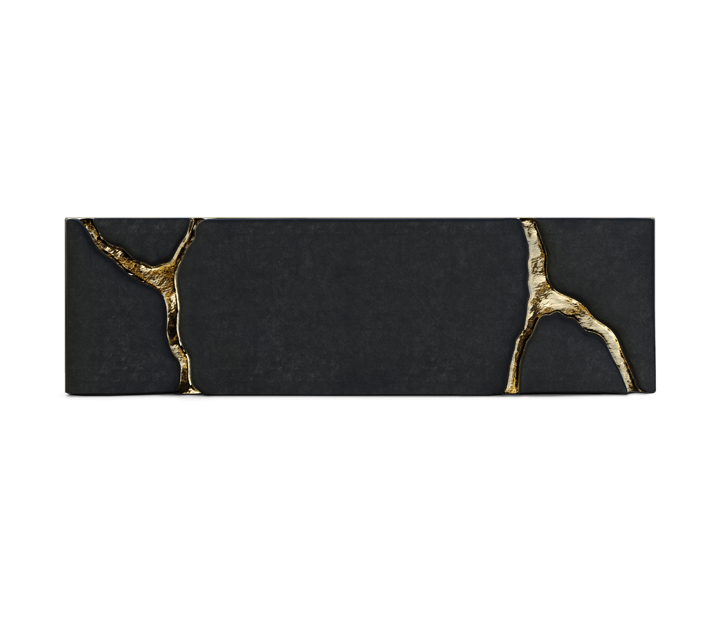 furniture detail highlighting a dark textured surface intersected by artistic gold-plated cracks