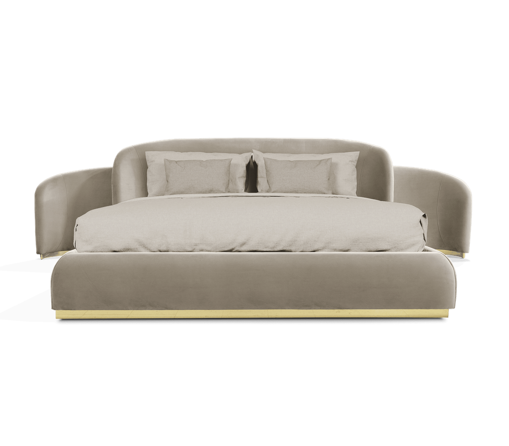 master bed featuring an enveloping upholstered headboard and a polished brass base