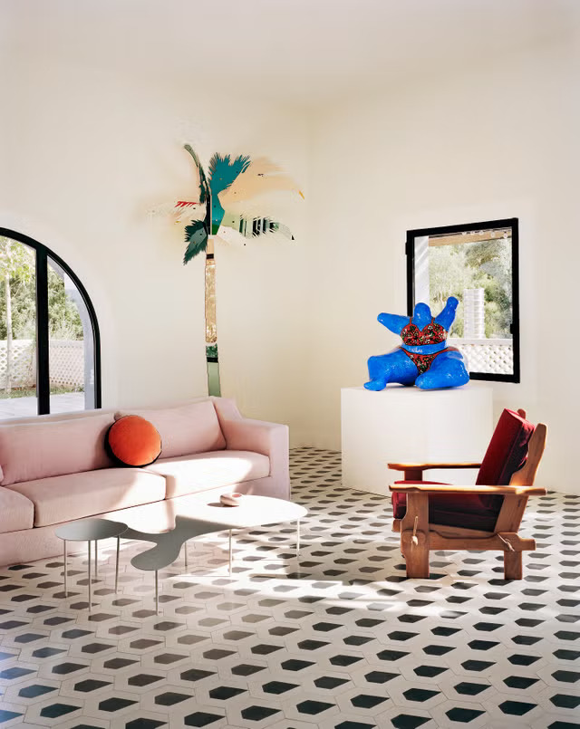 Artistic living room with pink sofa and sculptures, interior designers