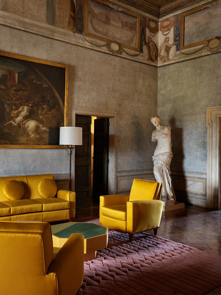 Classic room with yellow armchairs and classical statue, interior designers