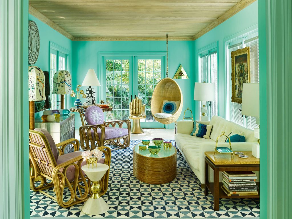 Vibrant turquoise room with swinging chair and colorful accents, interior designers