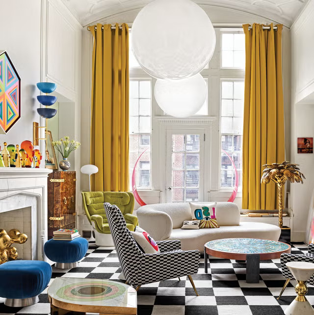 Eclectic living space with yellow curtains and geometric rug, interior designers