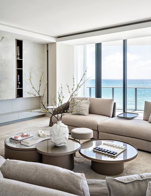 Modern coastal living room with round tables and ocean view, interior designers
