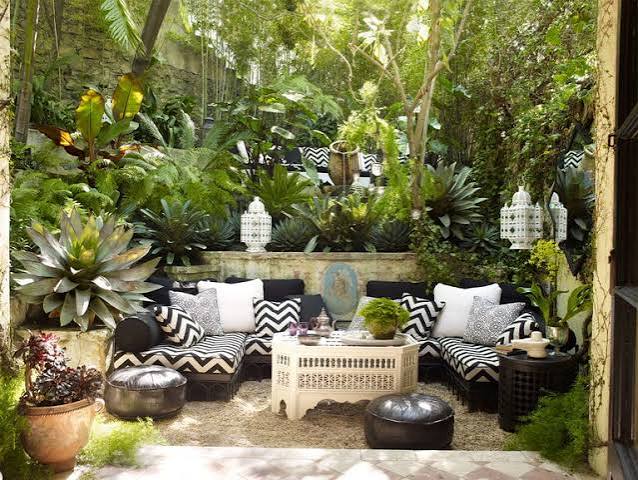 Boho patio with patterned outdoor sofa and plants, interior designers