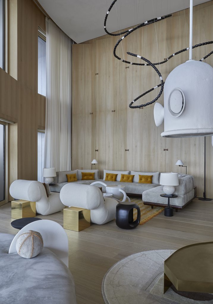 Contemporary open living room with unique light, luxury interior designers in India