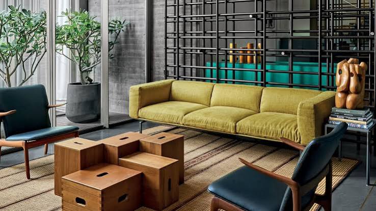 Modern lounge with yellow sofa and wood, luxury interior designers in India