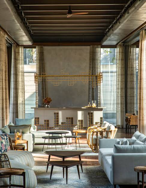 Modern seating area with sofas, nesting tables, luxury interior designers in India