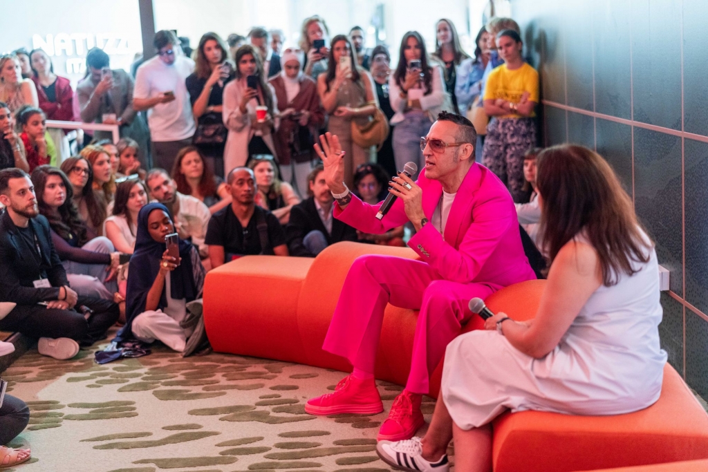 Discussion panel at Downtown Design Dubai 2025, with designer Karim Rashid speaking to an audience, emphasizing trends and insights in contemporary design.
