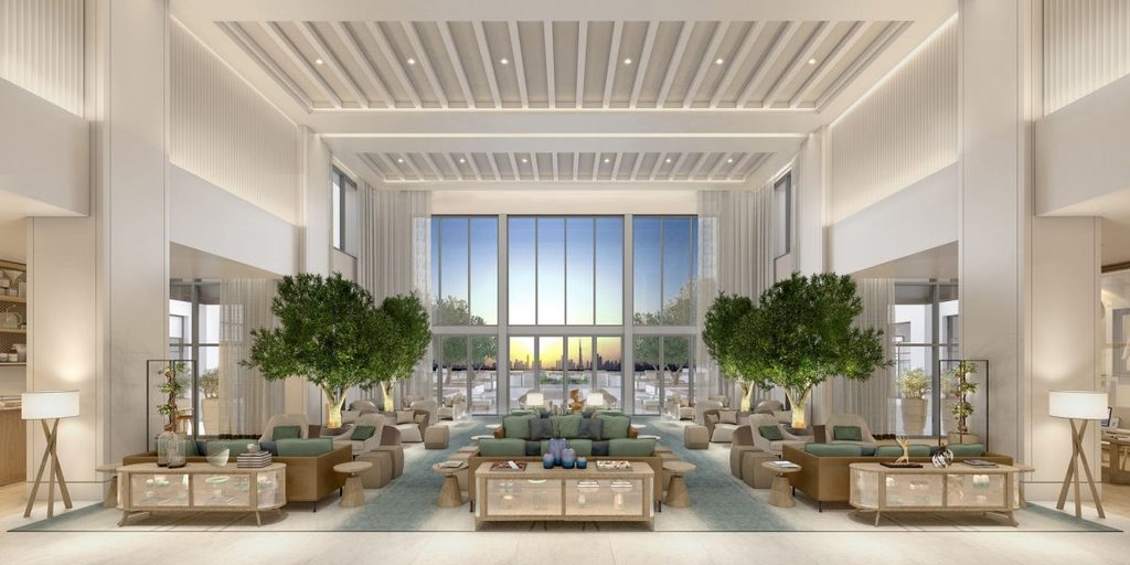 Grand hotel lobby with high ceiling and indoor trees, interior designers in Dubai