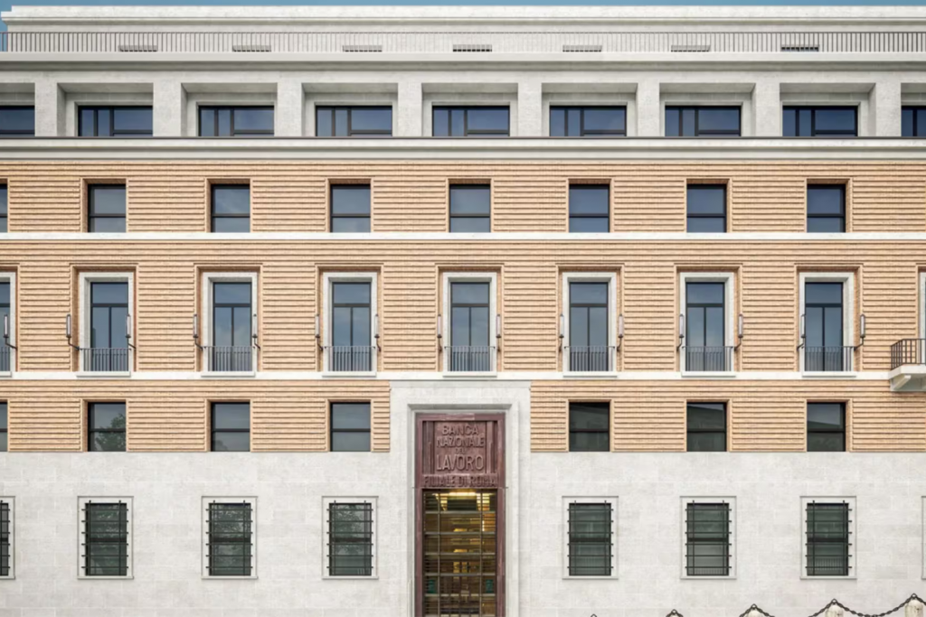 Luxury Hotels Opening in 2026, Neoclassical facade of the Banca Nazionale del Lavoro building in Rome with symmetrical windows and stone architecture.