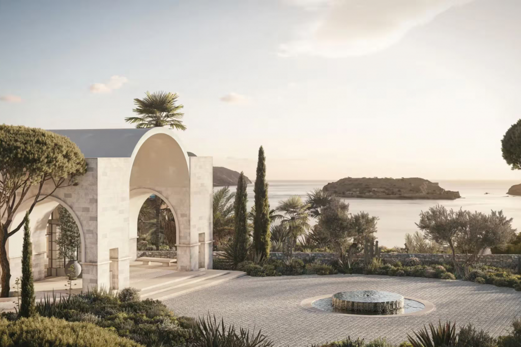 Luxury Hotels Opening in 2026, Mediterranean luxury resort entrance with white stone arches overlooking a fountain and the sea at sunset.