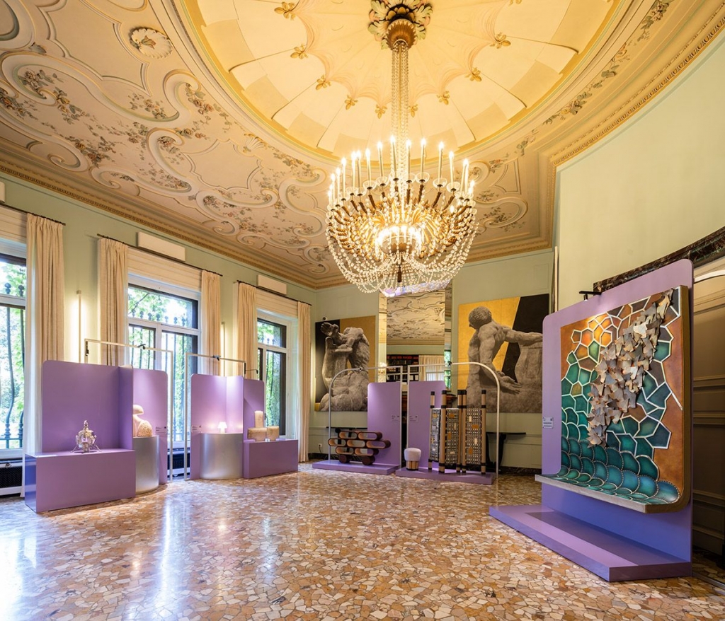 blue walls, gold chandelier, purple exibitions with art  Arts and Crafts