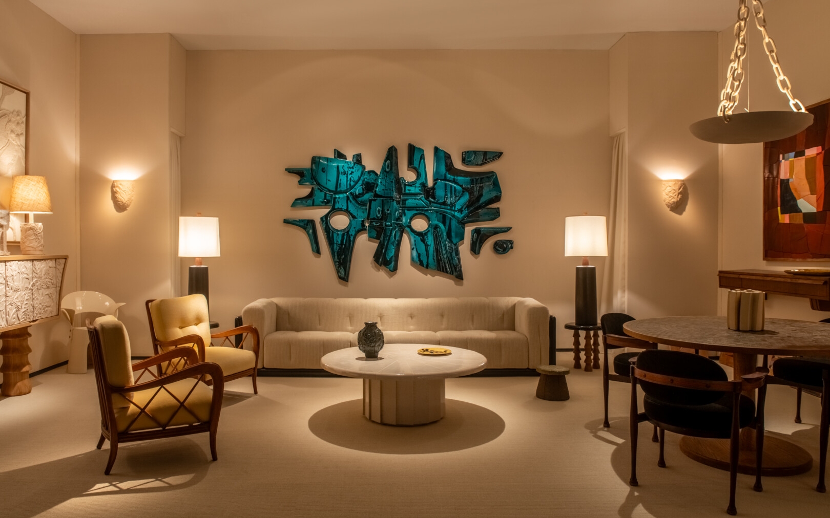 PAD Paris Design+Art 2026, Elegant collectible design living room at PAD Paris Design+Art 2026 featuring sculptural wall art, neutral sofa and refined lighting
