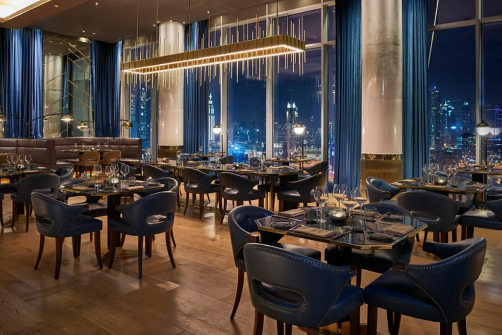 Bull and Bear DIFC, Luxury restaurant interior with blue chairs and gold lights