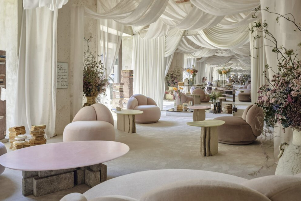 Collectible design installation at Milan Design Week showcasing sculptural furniture, soft neutral tones, draped fabric ceiling and curated artistic interior atmosphere. Milan Design Week 2026
