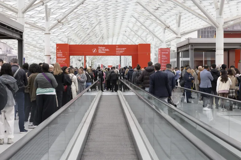 Professionals attending a Luxury Contract Design exhibition at Salone del Mobile Milano, showcasing contemporary architectural structure and industry networking.