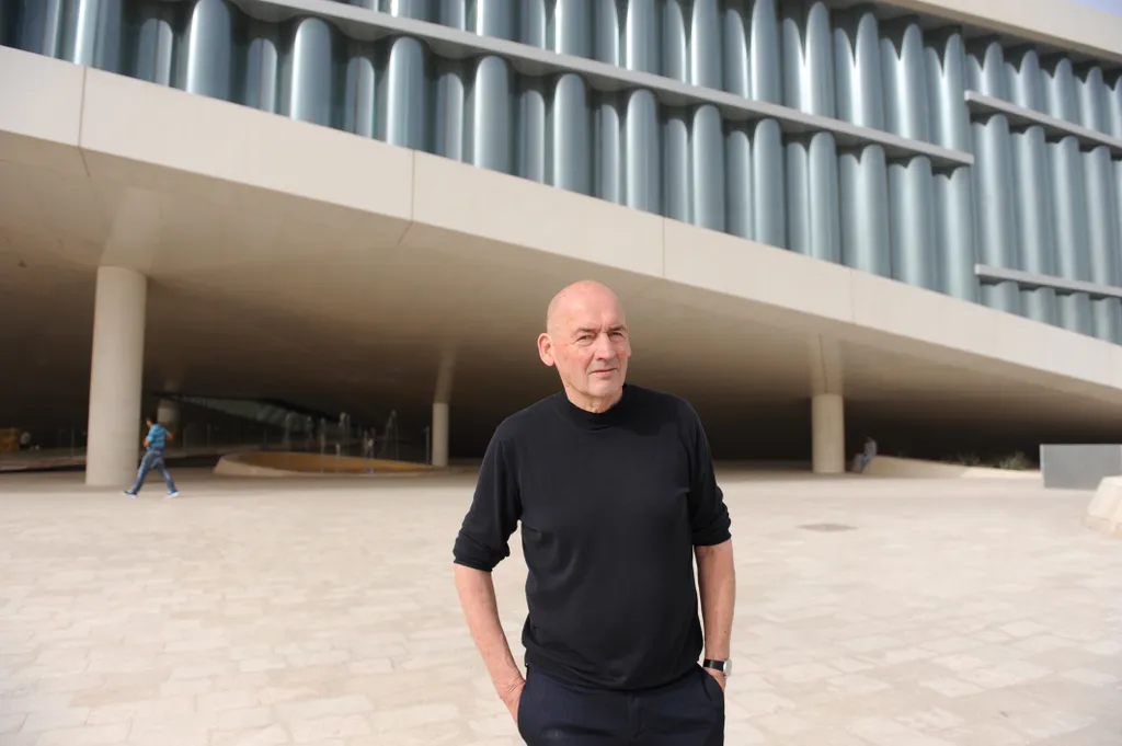 Architect standing before a contemporary monumental building symbolizing the global expansion of Luxury Contract Design and the evolution of high-end integrated interiors in 2026.