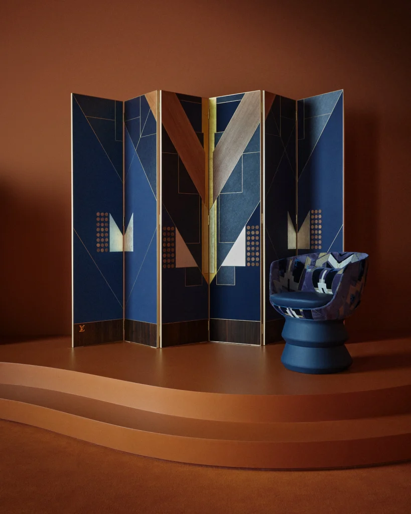Geometric blue and yellow folding screen paired with a matching upholstered stool. Objets Nomades