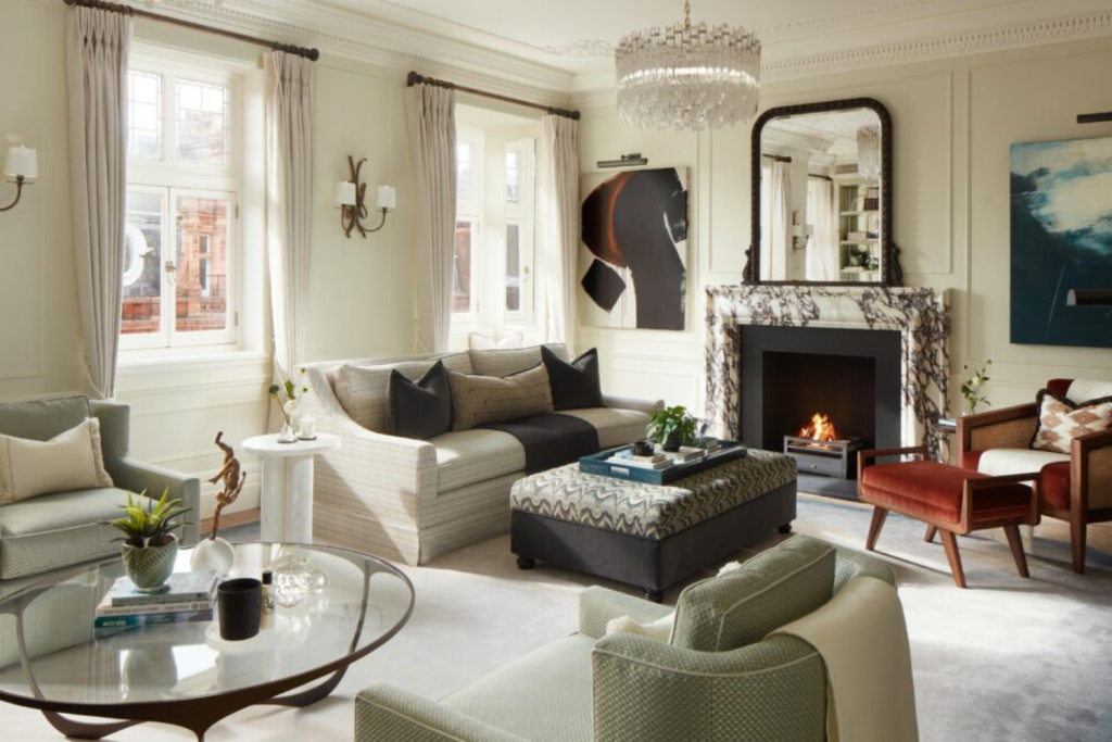 Candy London, Sophisticated high-end living room with marble fireplace, crystal chandelier, bespoke furniture, and balanced neutral tones in a classic contemporary interior.