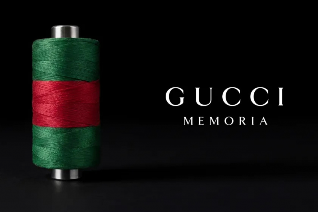 Design Week fashion events, Gucci Memory exhibition visual identity featuring green and red thread spool symbolizing heritage craftsmanship and brand history reinterpretation.