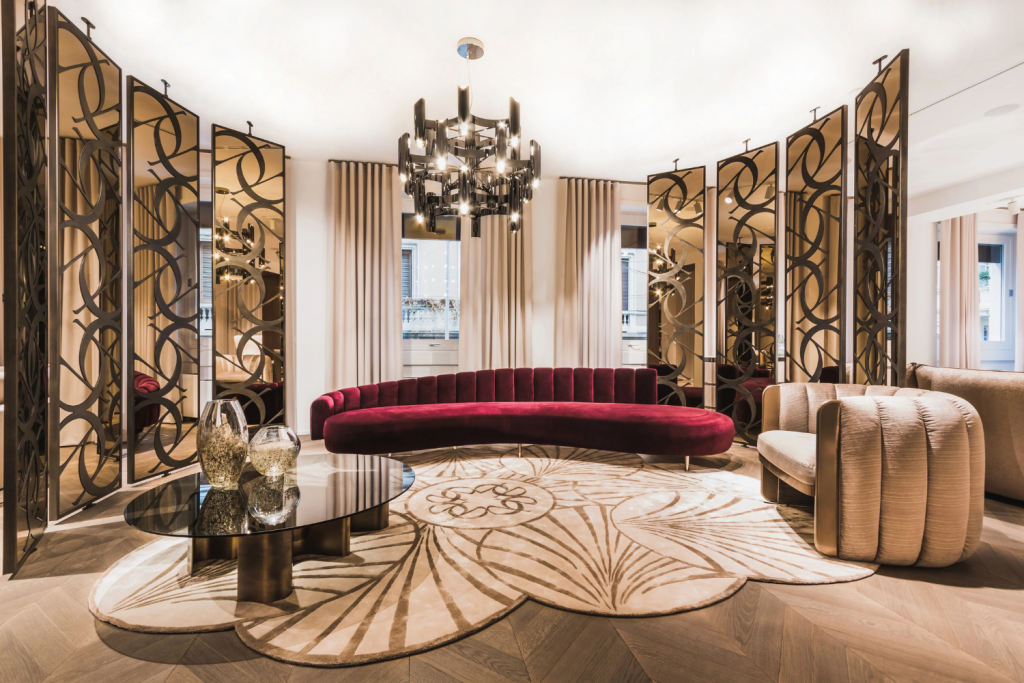 Design Week fashion events, luxury interior setting featuring sculptural furniture, velvet sofa and decorative screens reflecting contemporary collectible design aesthetics.