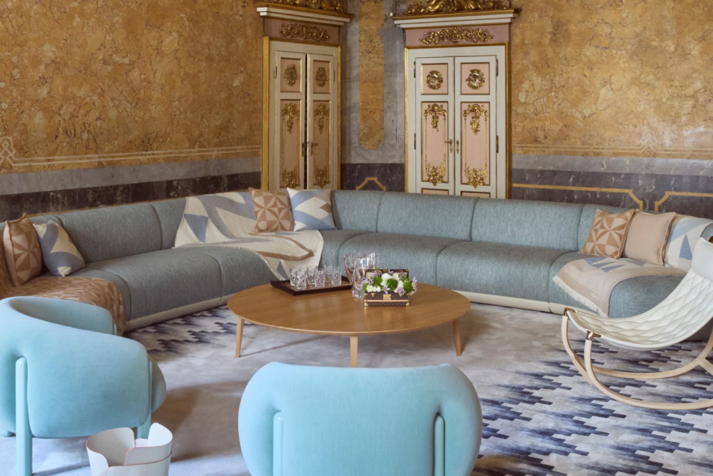 Design Week fashion events, Louis Vuitton Objets Nomades interior installation featuring refined pastel-toned seating and contemporary collectible furniture presented inside a historic Milanese palazzo.