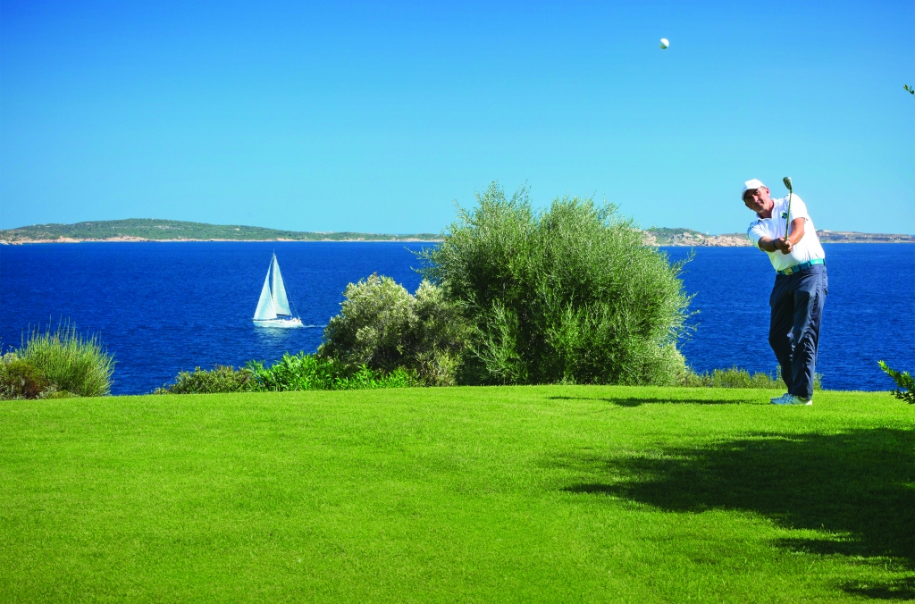 man playing gold with sea views