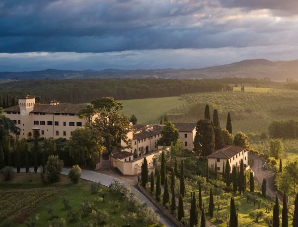 old money style, COMO Castello del Nero is a luxury hotel set within a restored 12th-century castle in the heart of Tuscany. Surrounded by rolling vineyards, olive groves, and picturesque countryside, the property blends historic architecture with contemporary elegance and renowned wellness experiences.