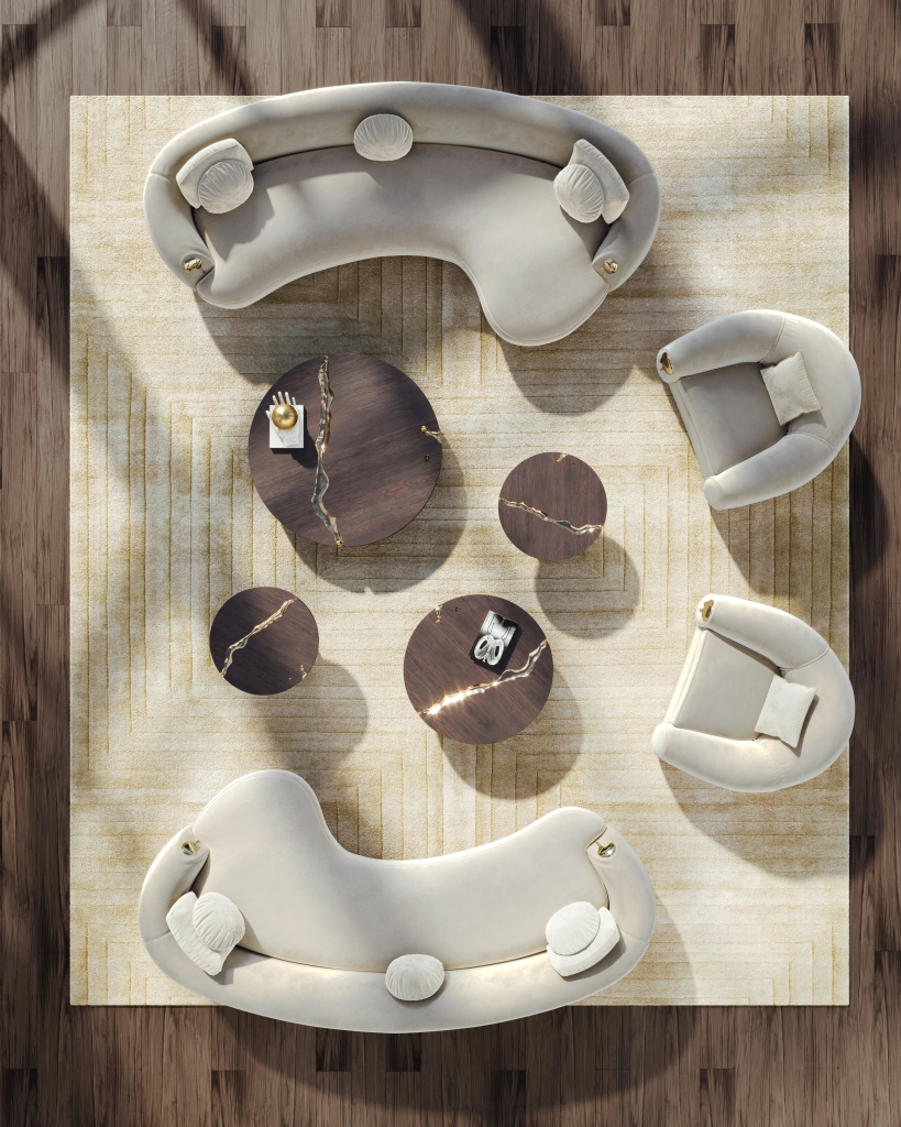 Bird's-eye view of a luxury living room arrangement featuring two curved cream velvet crescent sofas, two rounded ivory armchairs, and four dark walnut round coffee tables with gold kintsugi detailing on a champagne geometric rug living rooms