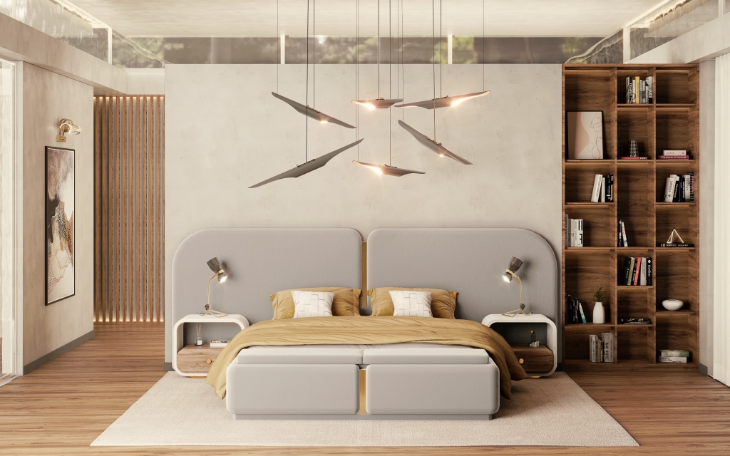 Modern and minimalist bedroom featuring a large beige upholstered bed with an integrated curved headboard. The bed is dressed in golden-yellow linens. On either side, there are white rounded nightstands with small lamps. Above the bed hangs a dramatic, sculptural multi-piece pendant light fixture. To the right, a tall, open wooden bookshelf is filled with books and decorative objects against a textured concrete-look wall. luxury bedrooms