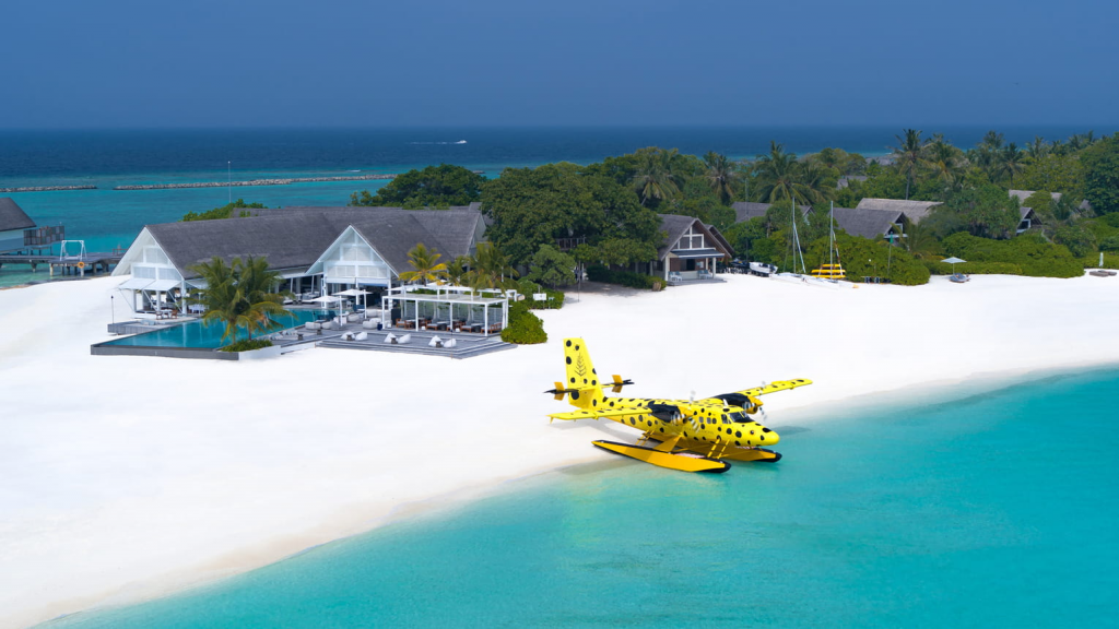 Four Seasons Hotels Resort Maldives at Landaa Giraavaru aerial view featuring luxury overwater and beachfront villas, white sandy beach, and turquoise ocean in the Maldives.