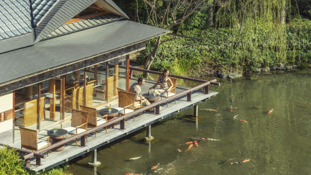 Four Seasons Hotels Hotel Kyoto interior view featuring the luxury restaurant area with traditional Japanese design, koi pond, and elegant dining atmosphere in Kyoto, Japan.
