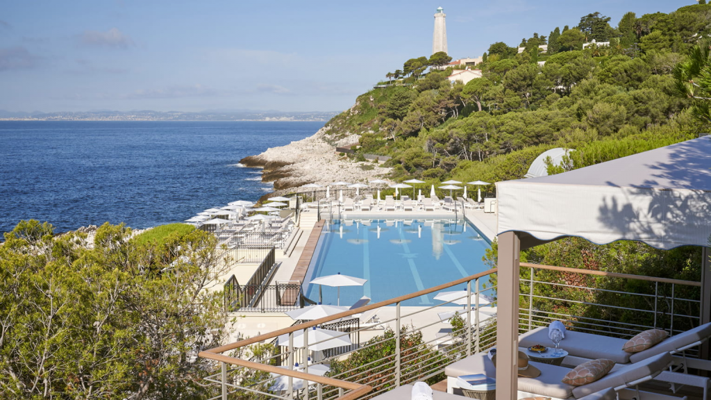 Four Seasons Hotels Grand-Hôtel du Cap-Ferrat exterior view featuring the luxury hotel pool surrounded by Mediterranean landscape and the French Riviera scenery in France.