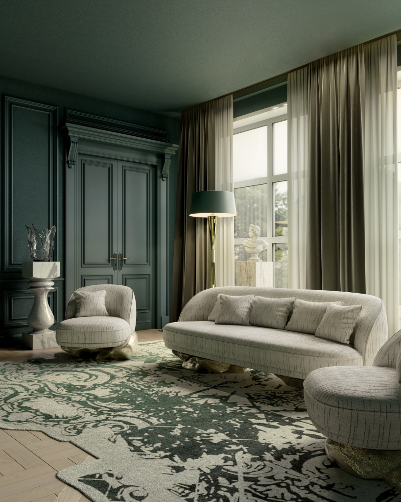 Moody hunter green living room with classical panelled walls and corniced doorway, curved cream textured sofa with gold sculptural base, matching round armchair, dark teal floor lamp, and bold damask-patterned green and ivory rug living rooms