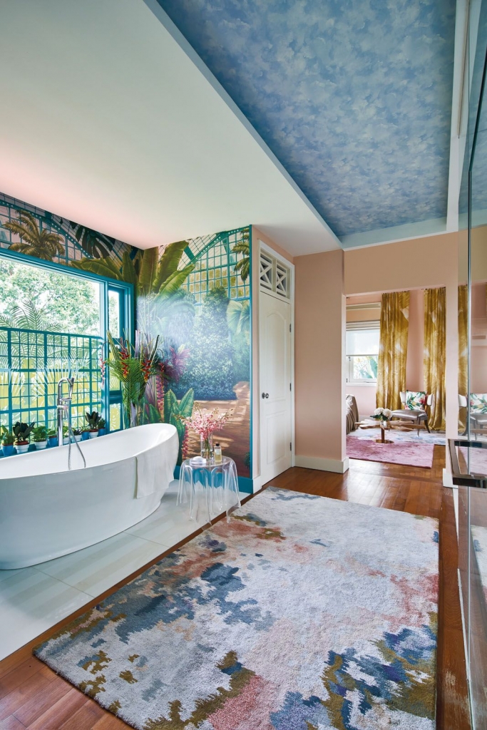 Nikki Hunt Interior Design, Bathroom with a white bathtub and tropical-style wallpaper in shades of blue and green