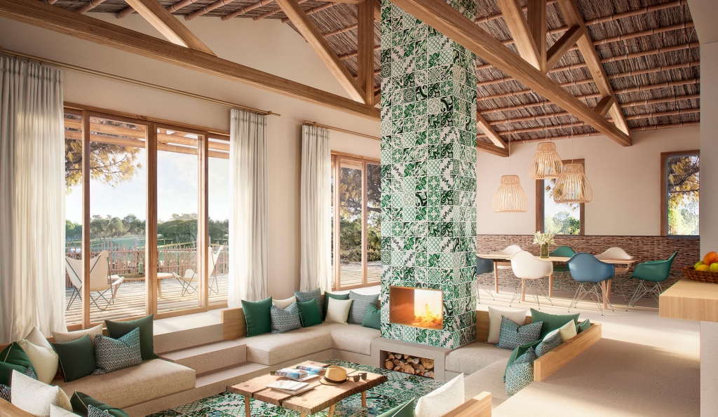 Mediterranean-inspired lounge and dining area with a green-and-white patterned tiled fireplace column, thatched wood-beam ceiling, sunken beige seating with green cushions, and rattan pendant lights. INTERIOR DESIGNERS