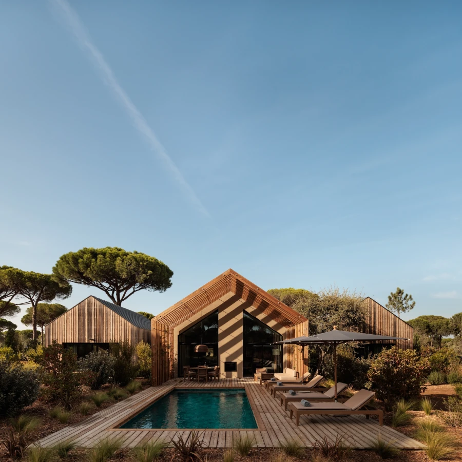 Portugal’s Bucket List Hotels — Sublime Comporta, a luxury eco-retreat surrounded by pine forests and dunes, featuring minimalist white architecture blending into the natural landscape.