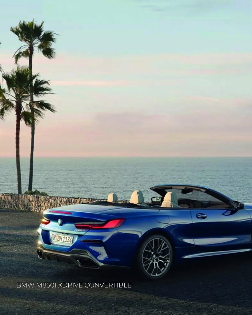 BMW M850i Convertible on open road, sporty luxury styling