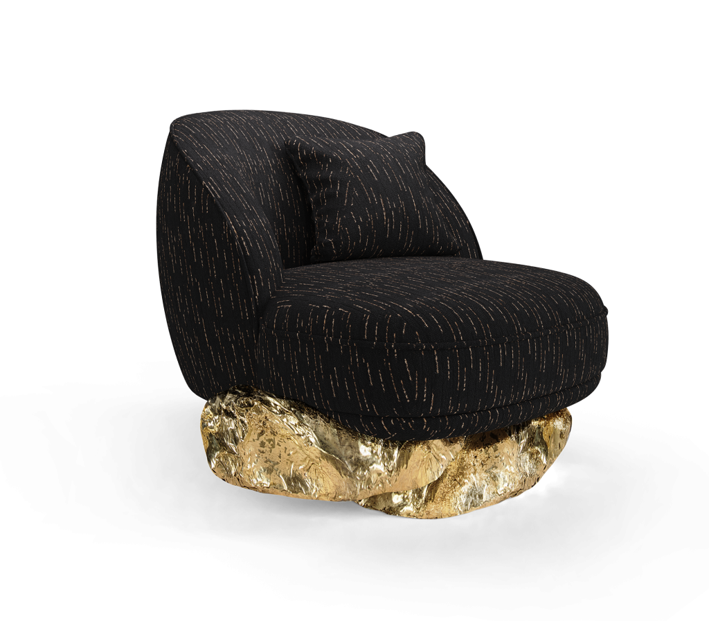 Black Angra armchair with textured upholstery and sculptural polished brass base isolated on a transparent background, luxury armchair.