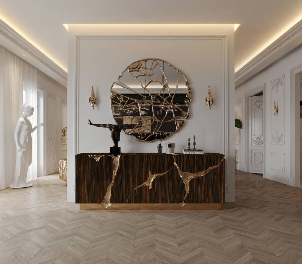 Round mirror with organic gold branch-shaped frame, above a dark wood console with gold accents-luxury mirrors.