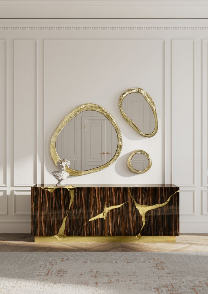 Set of three organic-shaped mirrors with irregular gold frames in different sizes, above a dark wood grain console-luxury mirrors.