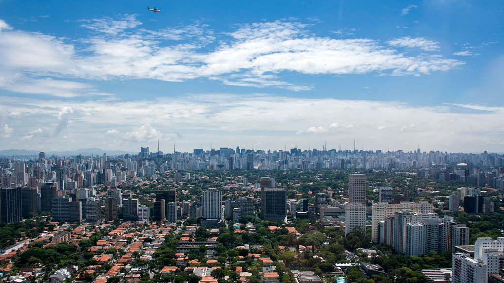 Top real state in São Paulo, Aerial view of São Paulo's prestigious Jardins neighborhood, featuring luxury residential buildings, tree-lined streets, lush greenery, and one of the city's most exclusive urban landscapes.