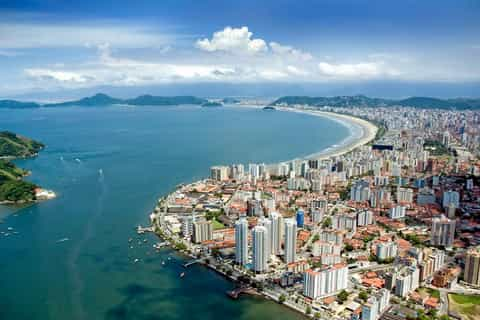Top real state in São Paulo, Aerial view of the São Paulo coastline, featuring sandy beaches, the Atlantic Ocean, lush greenery, and the region's scenic coastal landscape.
