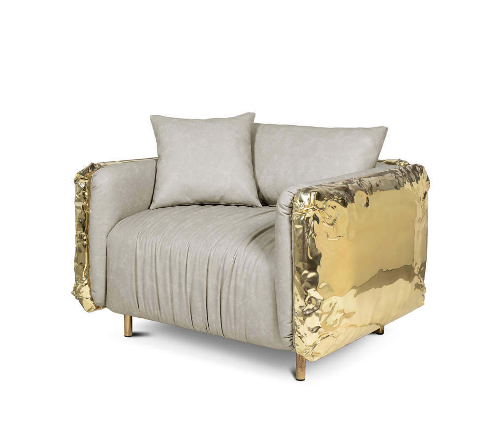 Beige upholstered Imperfectio armchair with polished brass sculptural side panels isolated on a transparent background, luxury armchair.