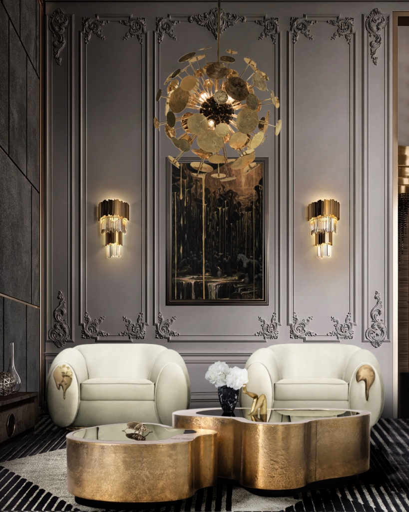 Two cream velvet swivel armchairs with molten gold arm accents, flanking a gold scalloped coffee table beneath a gold disc chandelier and crystal wall sconces- luxury armchair
