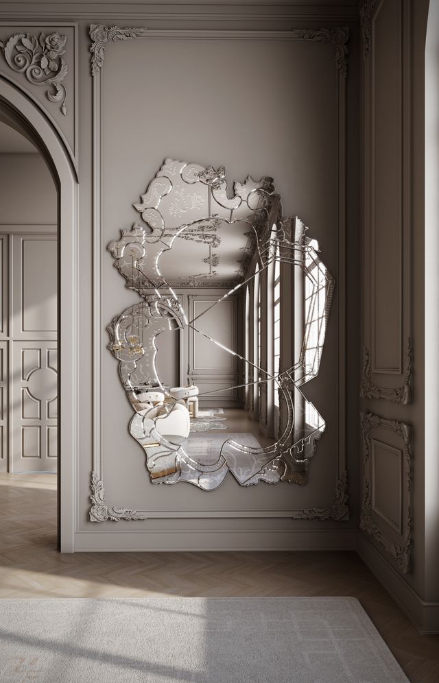 Organic-shaped Venetian mirror with beveled panels, mounted on a grey wall with classic molding-luxury mirrors.