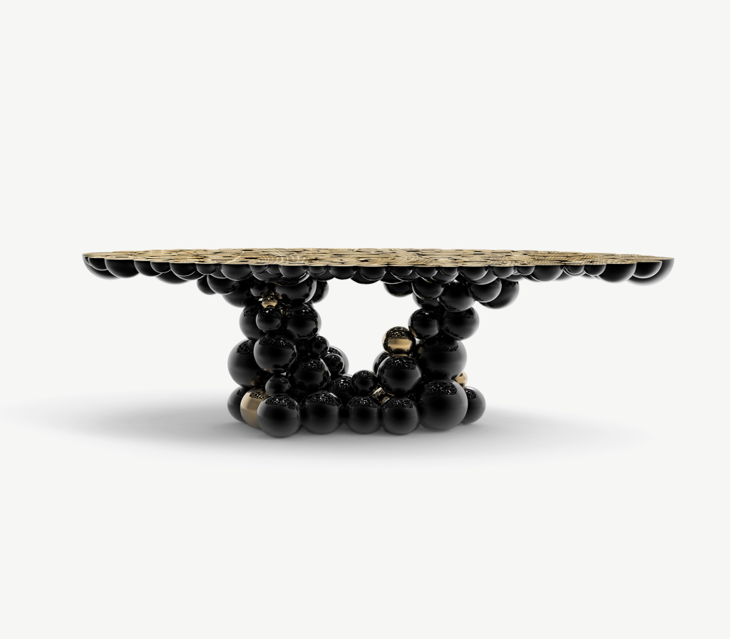 Oval table with black and gold stacked sphere cluster base, studio shot -luxury dining table