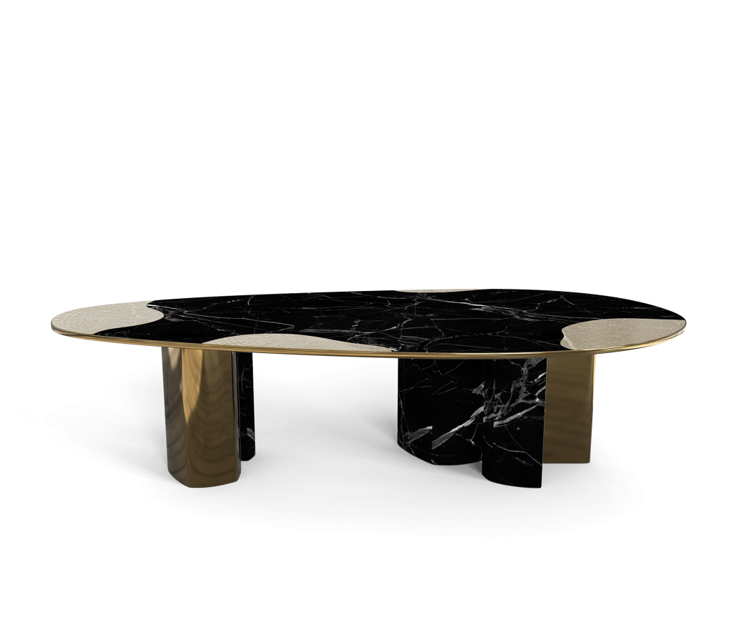 Oval black marble table with sculpted gold and marble geometric legs, studio shot -luxury dining table