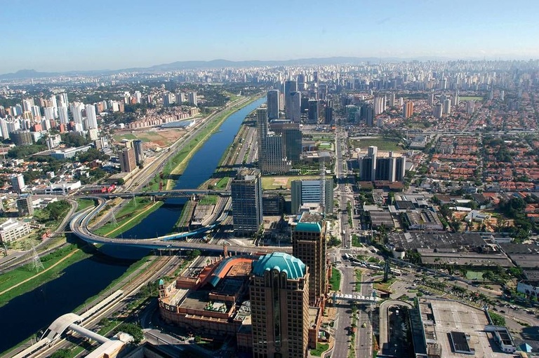Aerial view of an urban canal lined with avenues, bridges, and modern corporate towers -top places to live in São Paulo